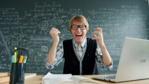 Professor going mad in front of a chalkboard