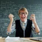 Professor going mad in front of a chalkboard